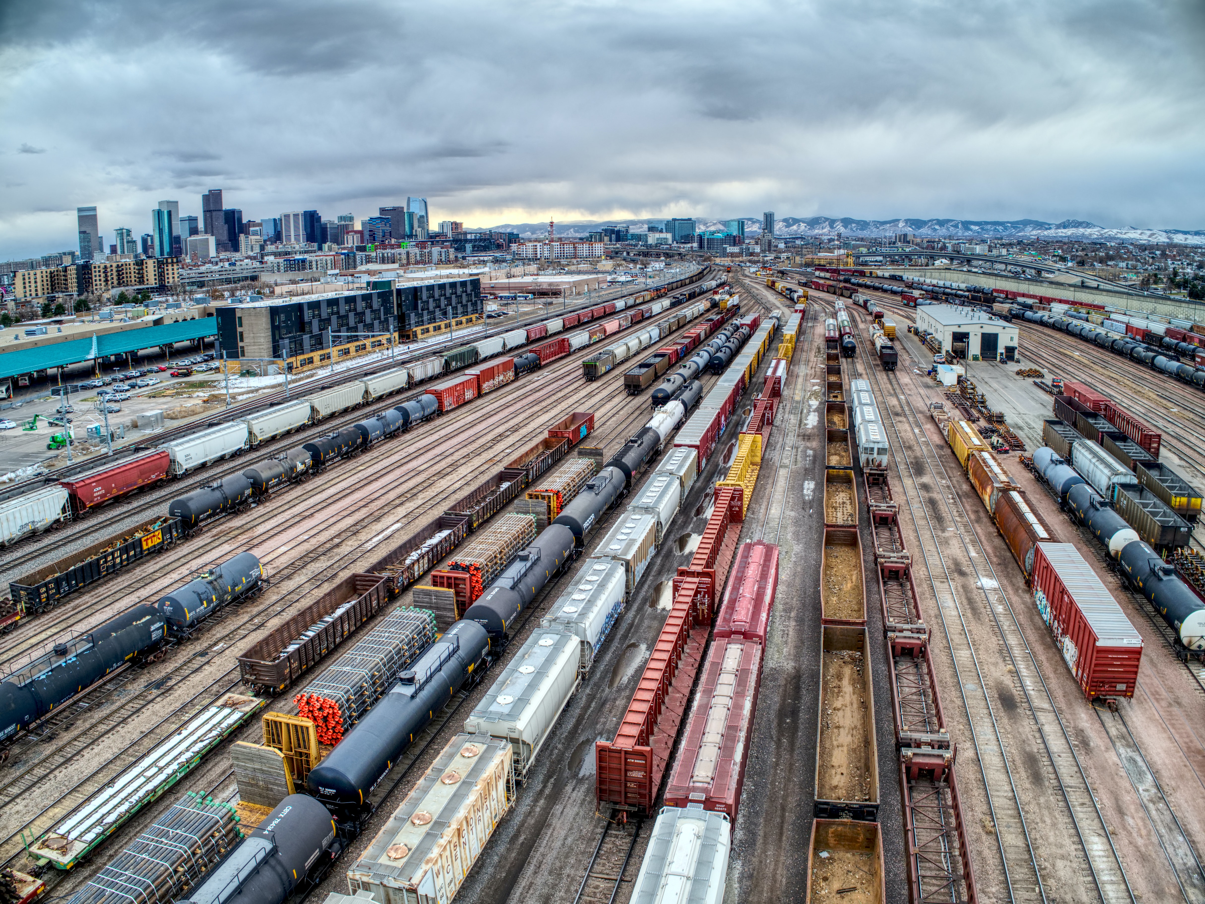 This is the alt text. There are trains on railway tracks with a cloudy sky.