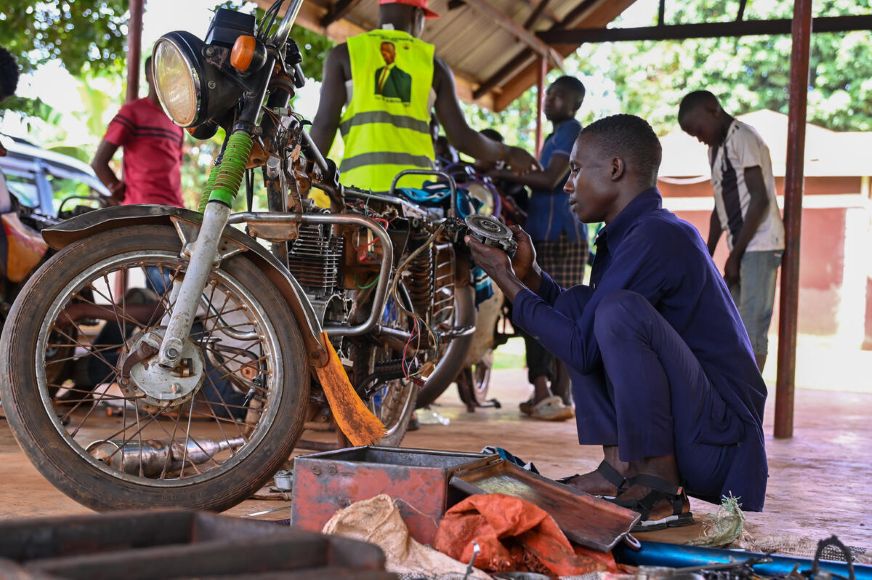 A young man is busy repairing a motorcycle. (Uganda, 2025)
