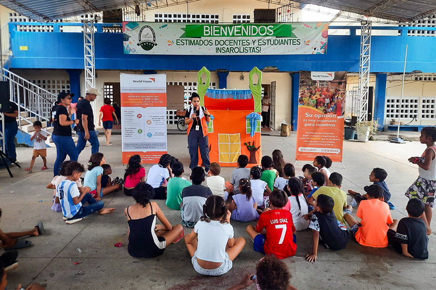 A group of children gather for a time of education after a many classrooms were disrupted from mass flooding.