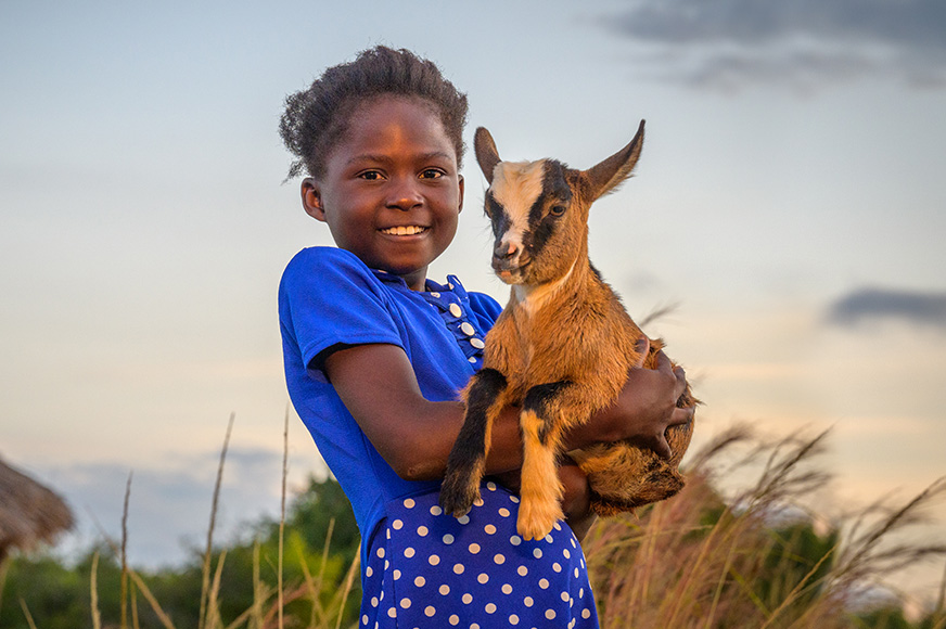 A girl holds one of her family’s goats in southern Zambia.