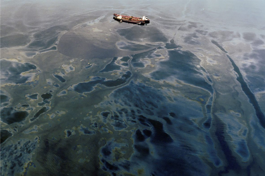 A tanker is surrounded by oil after the Exxon Valdez Oil Spill