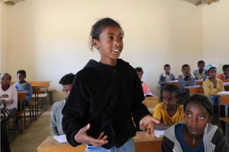 Lidiya speaks confidently during class after returning to school following years of conflict.
