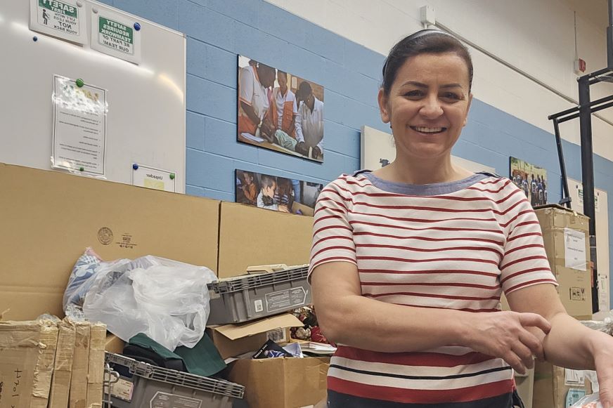 A woman wearing a red and white striped shirt smiles.