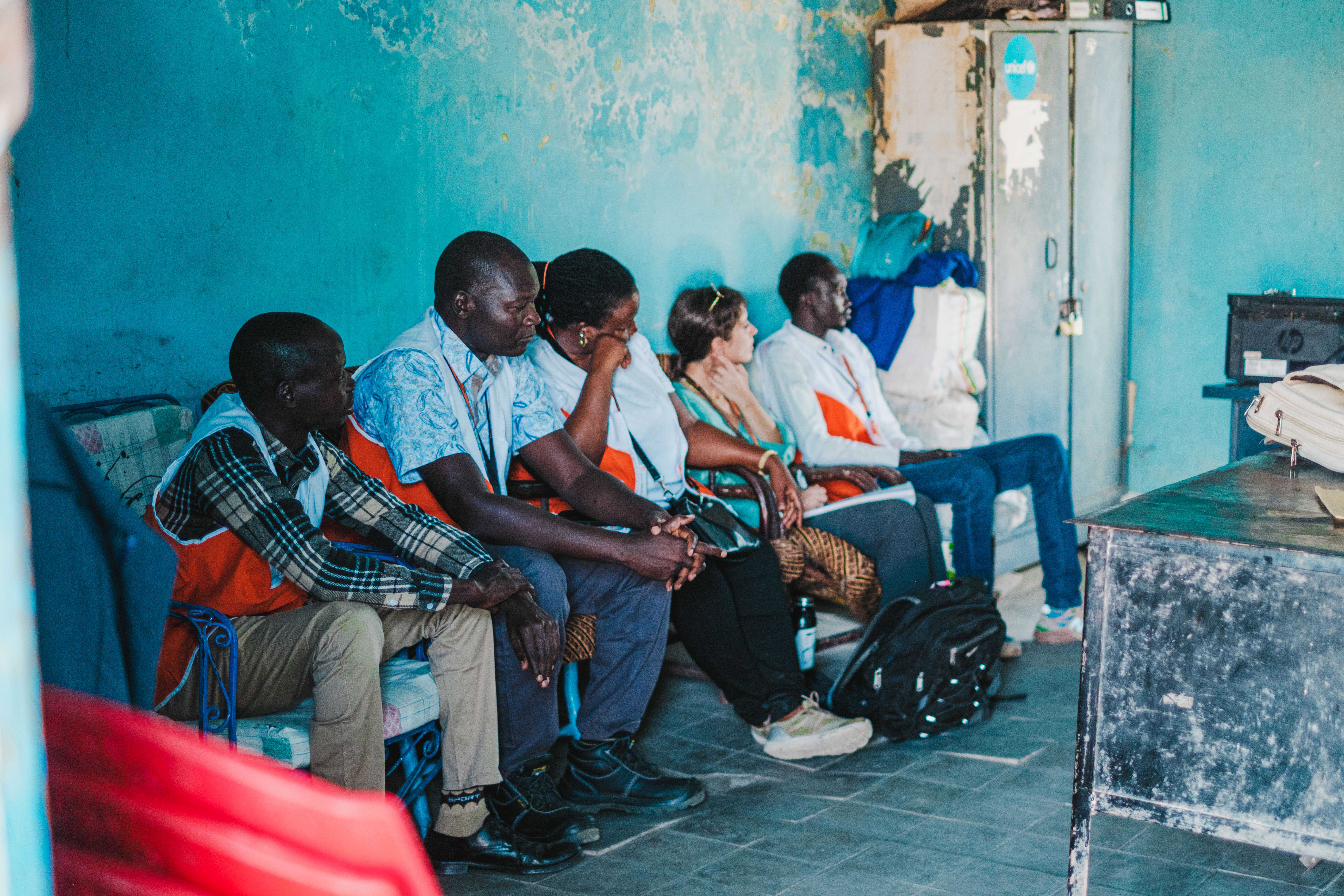 south_sudan_creating_safe_spaces_staff_sit_inside_school