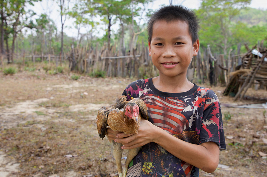 world-vision-canada-boy-carrying-a-small-chicken
