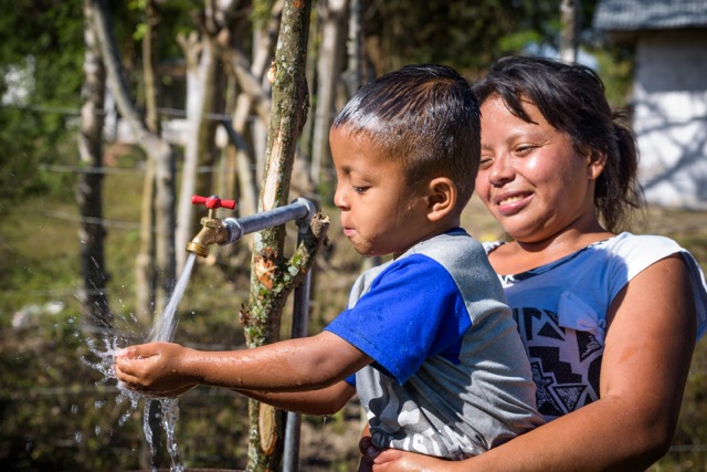 water-international-development-safe-water-child-plays-with-water