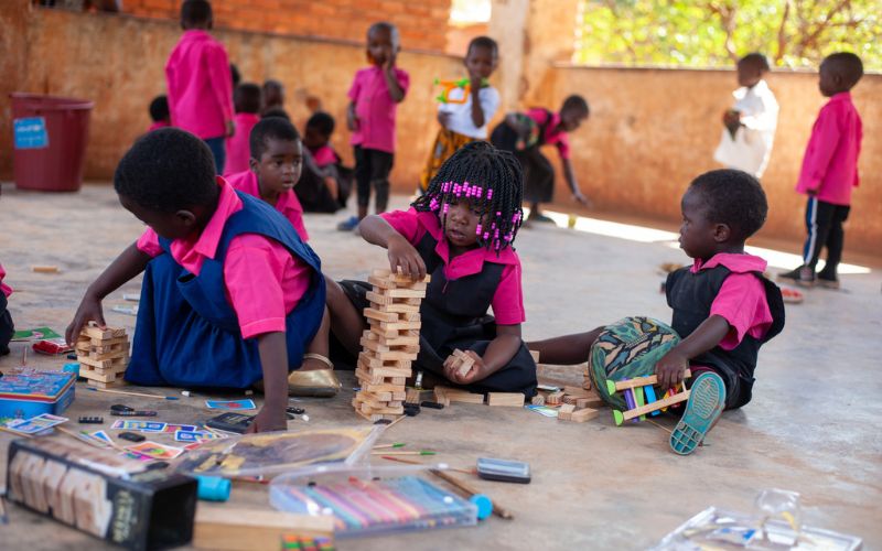 Horizontal blog image template - Charitable-giving-spinmaster-malawi-children-playing-jenga