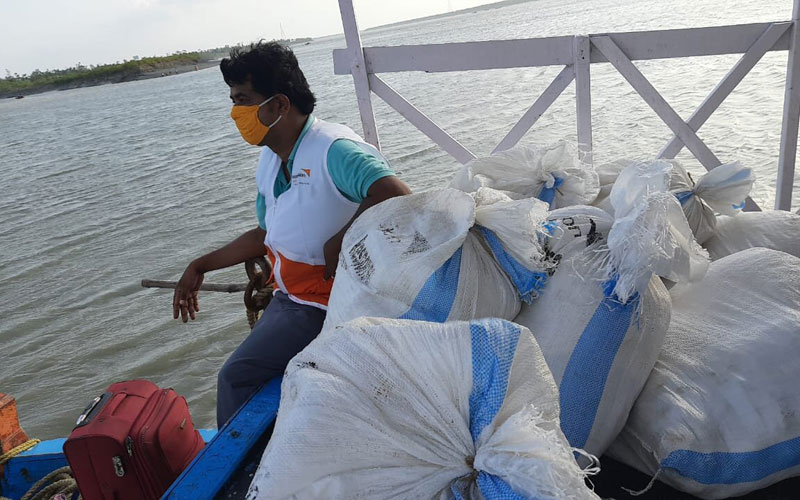 child-marriage-covid19-india-man-bags-supplies.