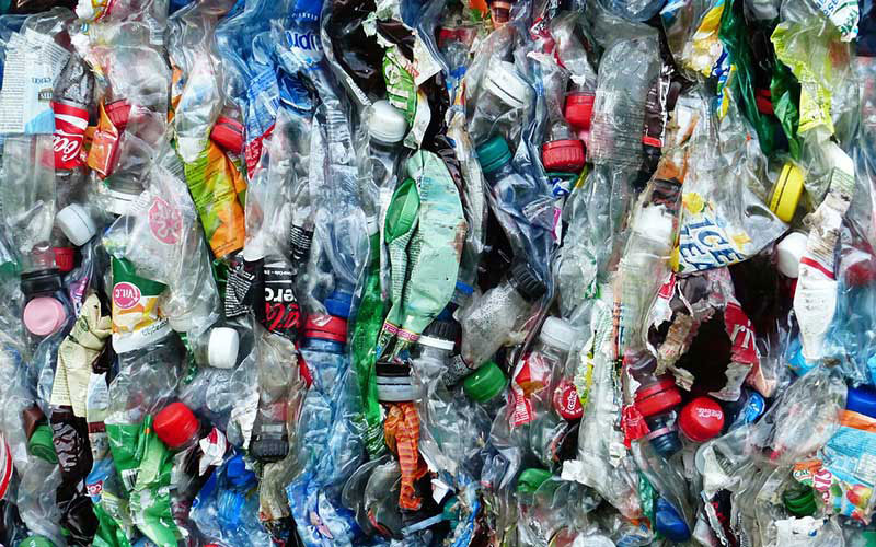 Garbage and recycled good squished together.