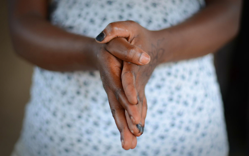 A black woman's hands clasped together.