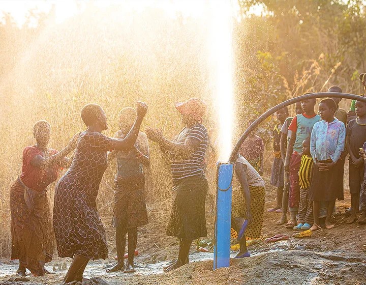 world-vision-canada-resources-a-group-of-people-celebrate-around-a-well.jpg