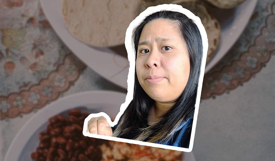 Plates of food in the background and a lady's face in the forefront.