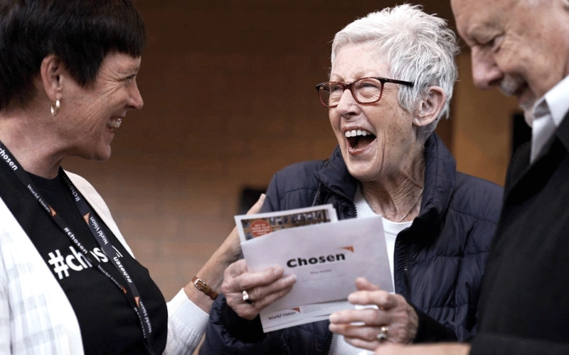 Coby, wife of Pastor Rob, shares a moment with a church congregant rejoicing over their Chosen child.
