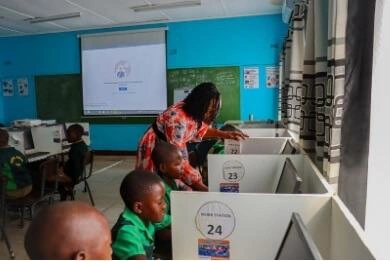 Children at Mhokwe Primary School leaning from their teacher about Icomputers