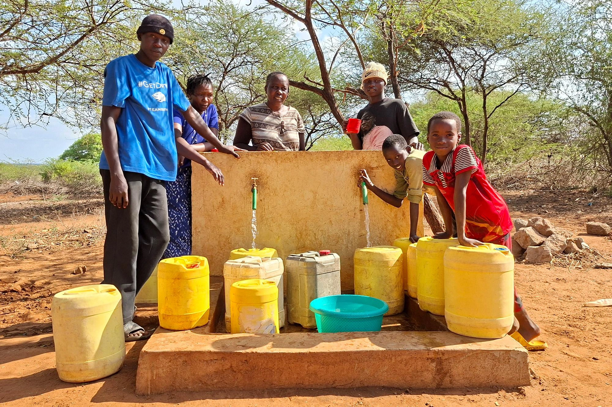 Riata Community Family Collects Water