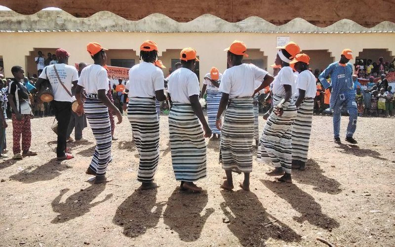 A group of adolescent girls stand in a circle.
