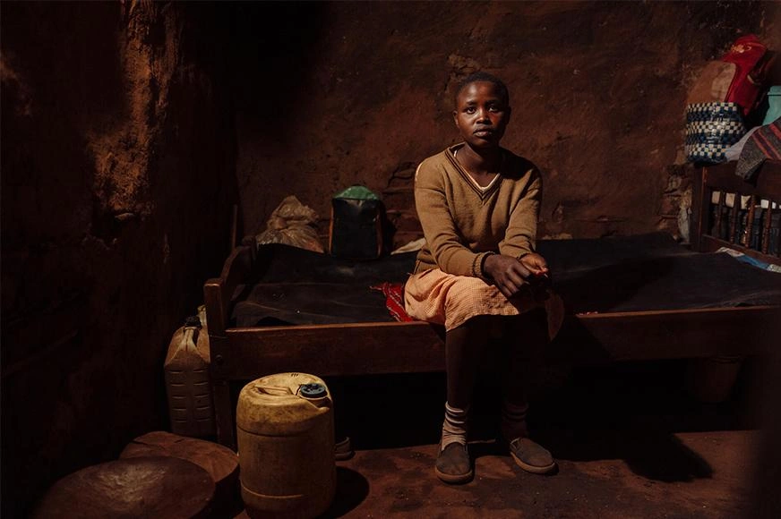 cutting-ties-with-fgm-girl-sitting-on-bed-inside-a-dark-room