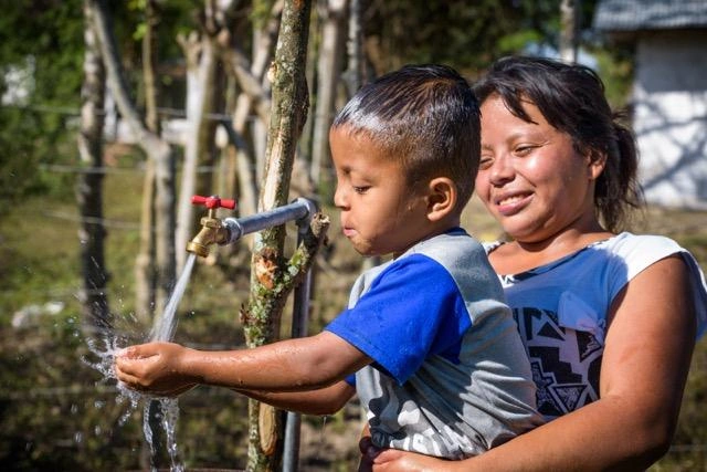 water-international-development-safe-water-child-plays-with-water
