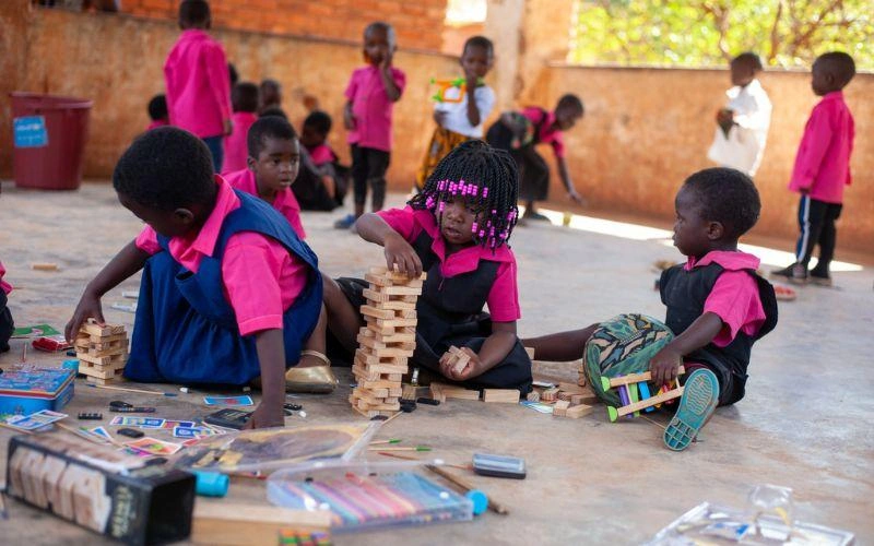 Horizontal blog image template - Charitable-giving-spinmaster-malawi-children-playing-jenga
