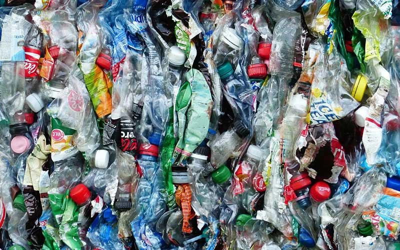 Garbage and recycled good squished together.