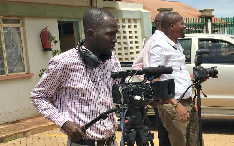A man operates a video camera.