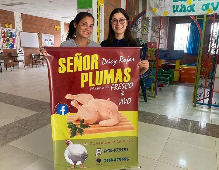 world-vision-canada-resources-two-women-hold-up-sign-smiling.jpg