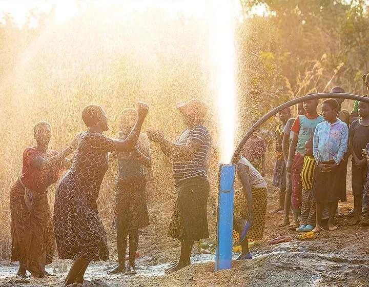 world-vision-canada-resources-a-group-of-people-celebrate-around-a-well.jpg