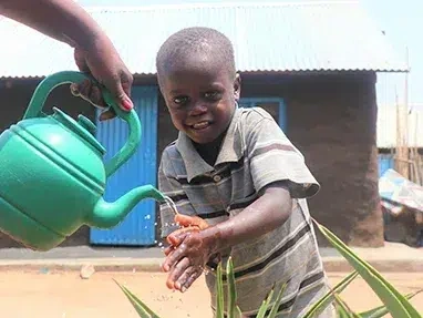 A boy is washing his hands practicing good hygiene to prevent diseases. (South Sudan, 2021)
