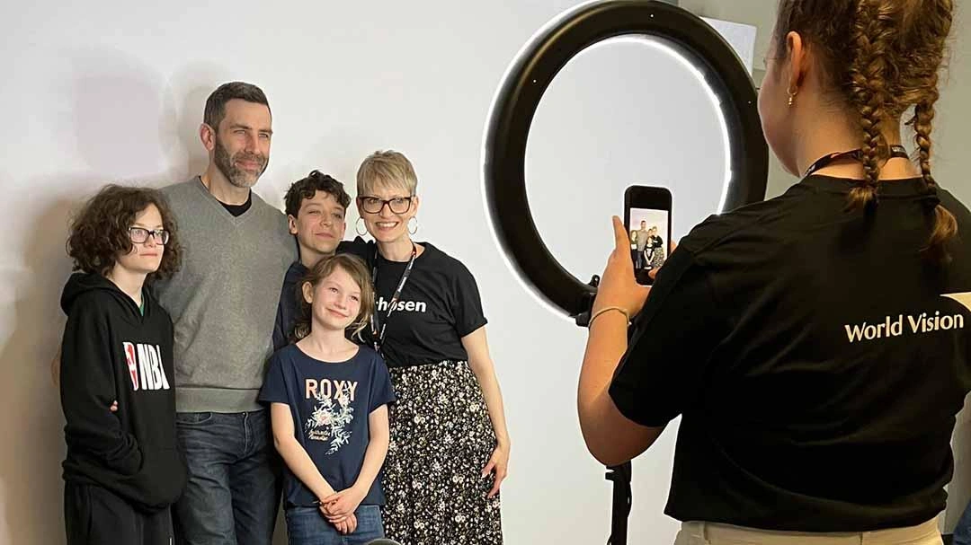 Family stands and smiles for their sponsor photo.