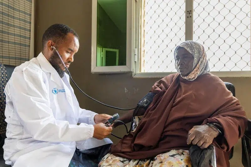 A doctor giving medical treatment to a mother.