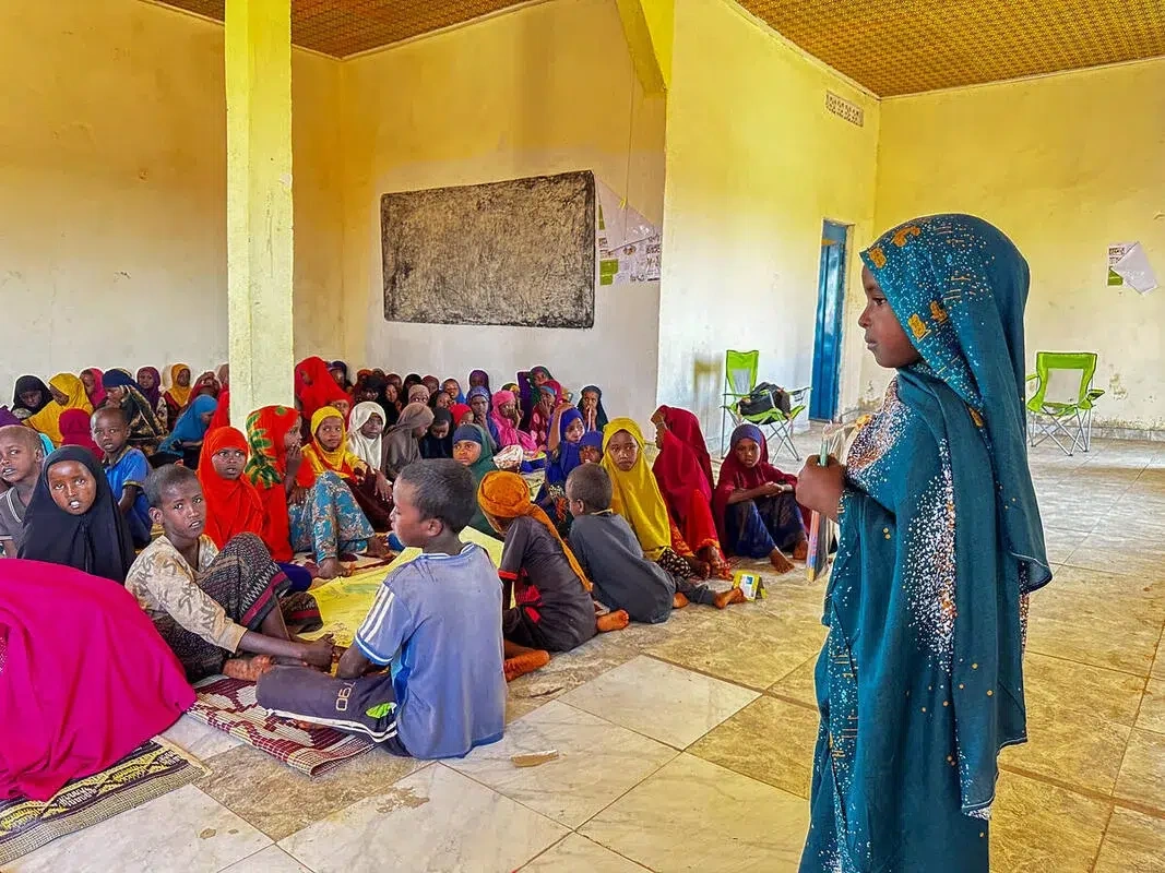 Sucdi presents in front of her class in Somalia.