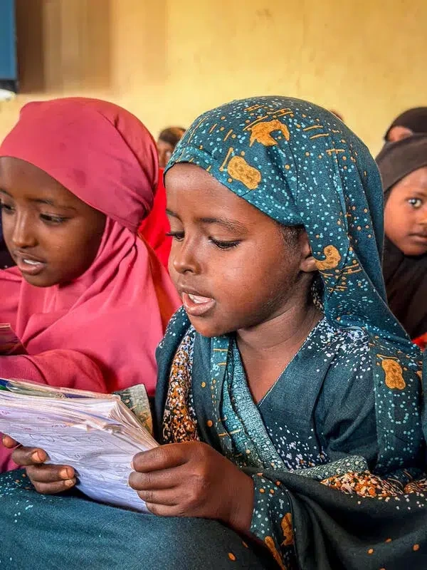 Sucdi reads in her class in the Child Friendly Space in Somalia.