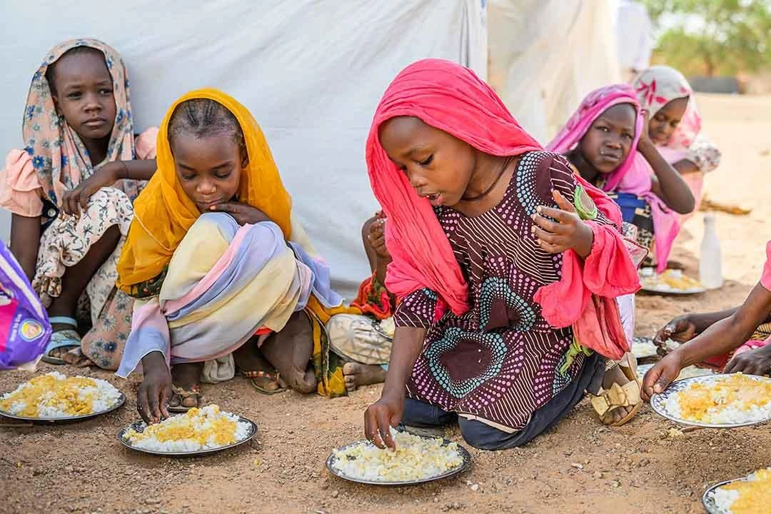 Children eat meals from a bowl.