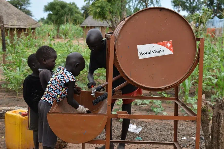 Yar teaches her siblings’ the proper way to wash their hands using facilities given by World Vision’s water, sanitation and hygiene program. (South Sudan, 2022)