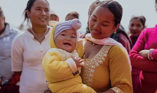 Mother carrying her baby
