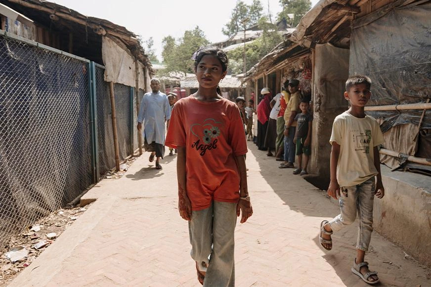 A Rohingya girl walks through Cox’s Bazar, a refugee camp in Bangladesh.