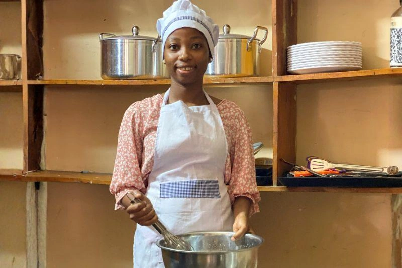 Eva smiles while working at her internship that provides for her family and is giving her job skills for the future.