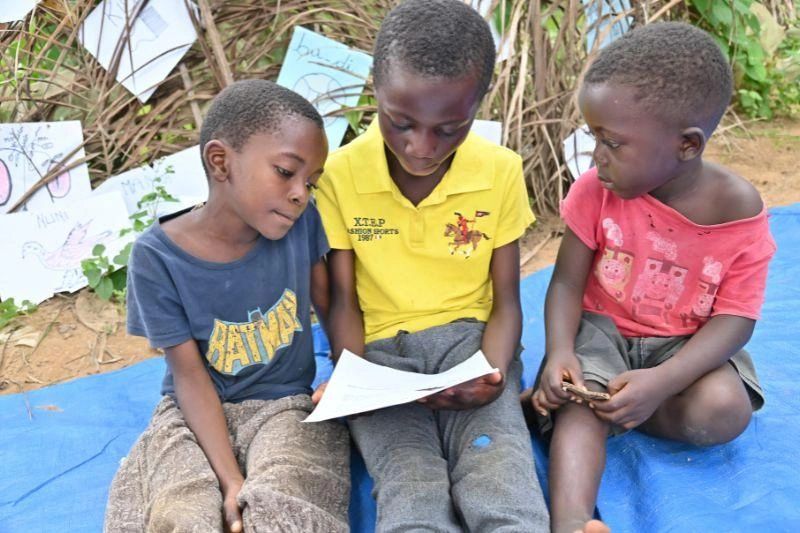 Friends at a reading club work together on class work.