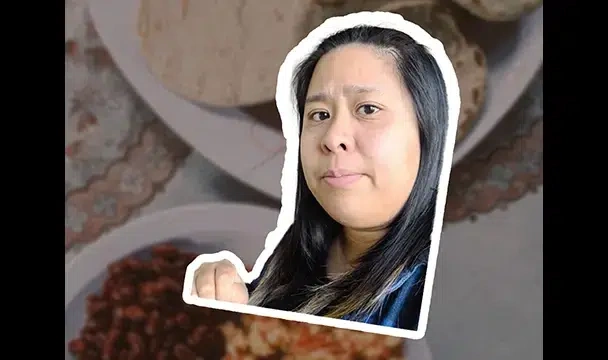Woman smiling, and an image of food on a table in the background