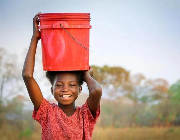 world-vision-canada-resources-girl-carries-red-bucket-on-her-head.jpg