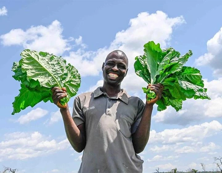 world-vision-canada-resources-man-holds-plants-smiling.jpg