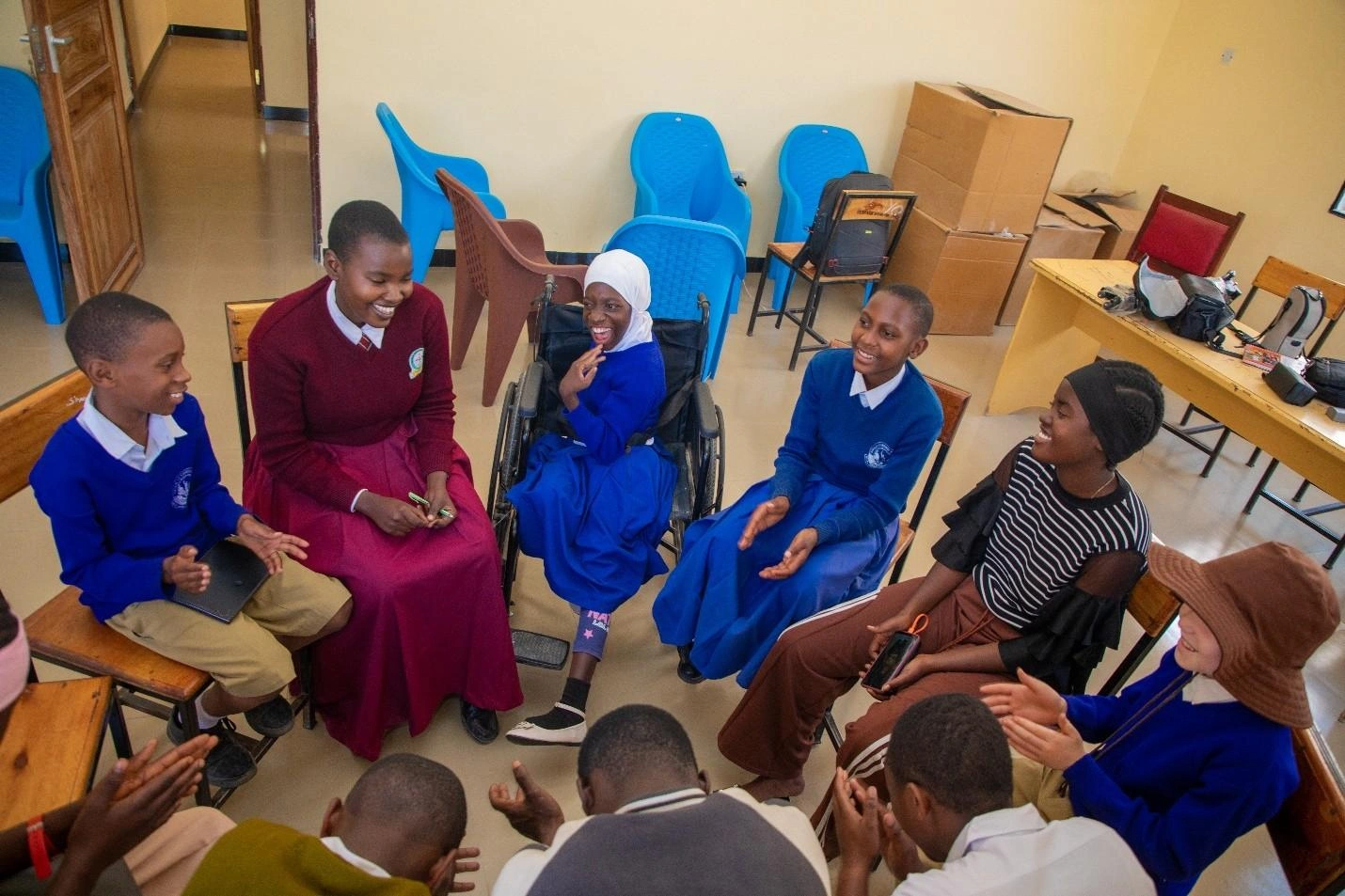 A group of youth sit in a circle.