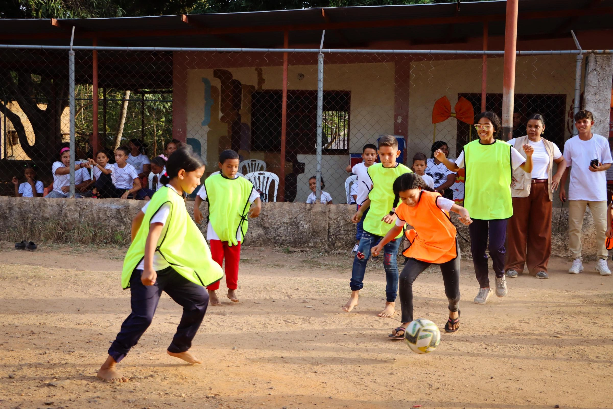 A group of children play soccer