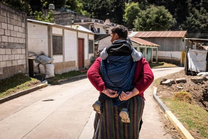 Sponsorship-nutrition-mom-carries-Efrain-through-village