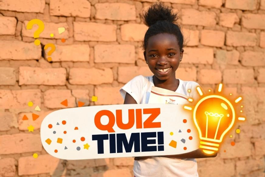 A young girl stands with her arms crossed while holding a notebook. She is positioned in front of a sunlit brick wall. A graphic overlay reads "Quiz Time!" with question marks and a light bulb icon.