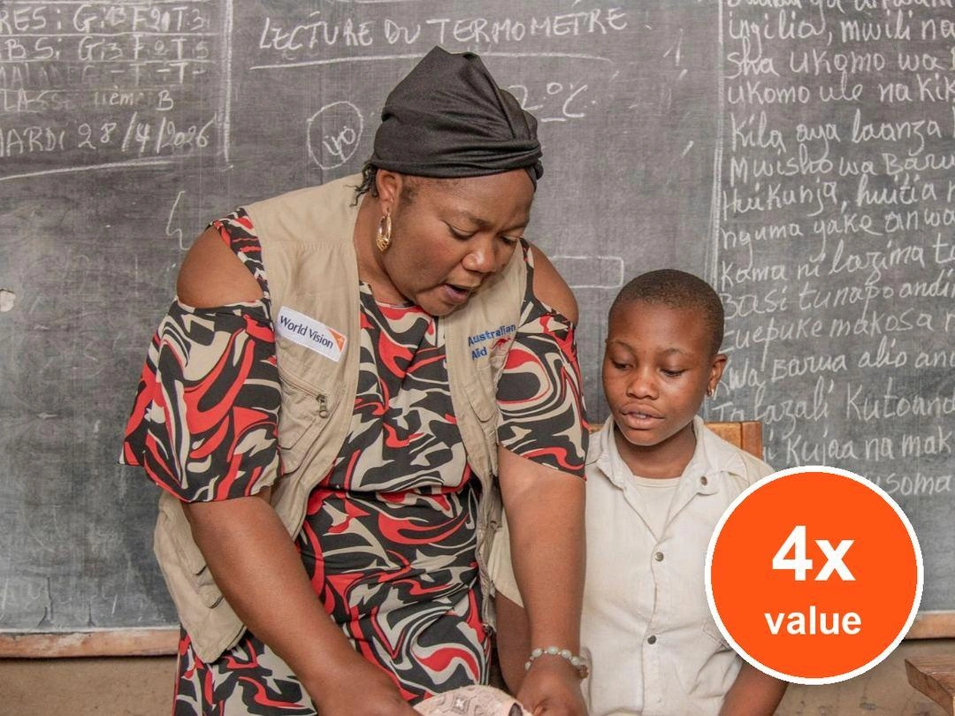 A woman teaches a female student how to use a sanitary pad. Badge: 4x value.