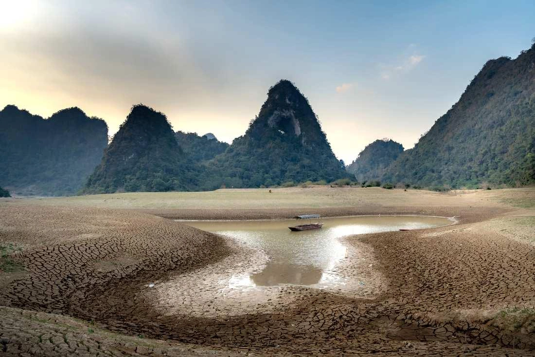 A drought-stricken lake shrinks to a small pool in Ninh Binh, Vietnam.