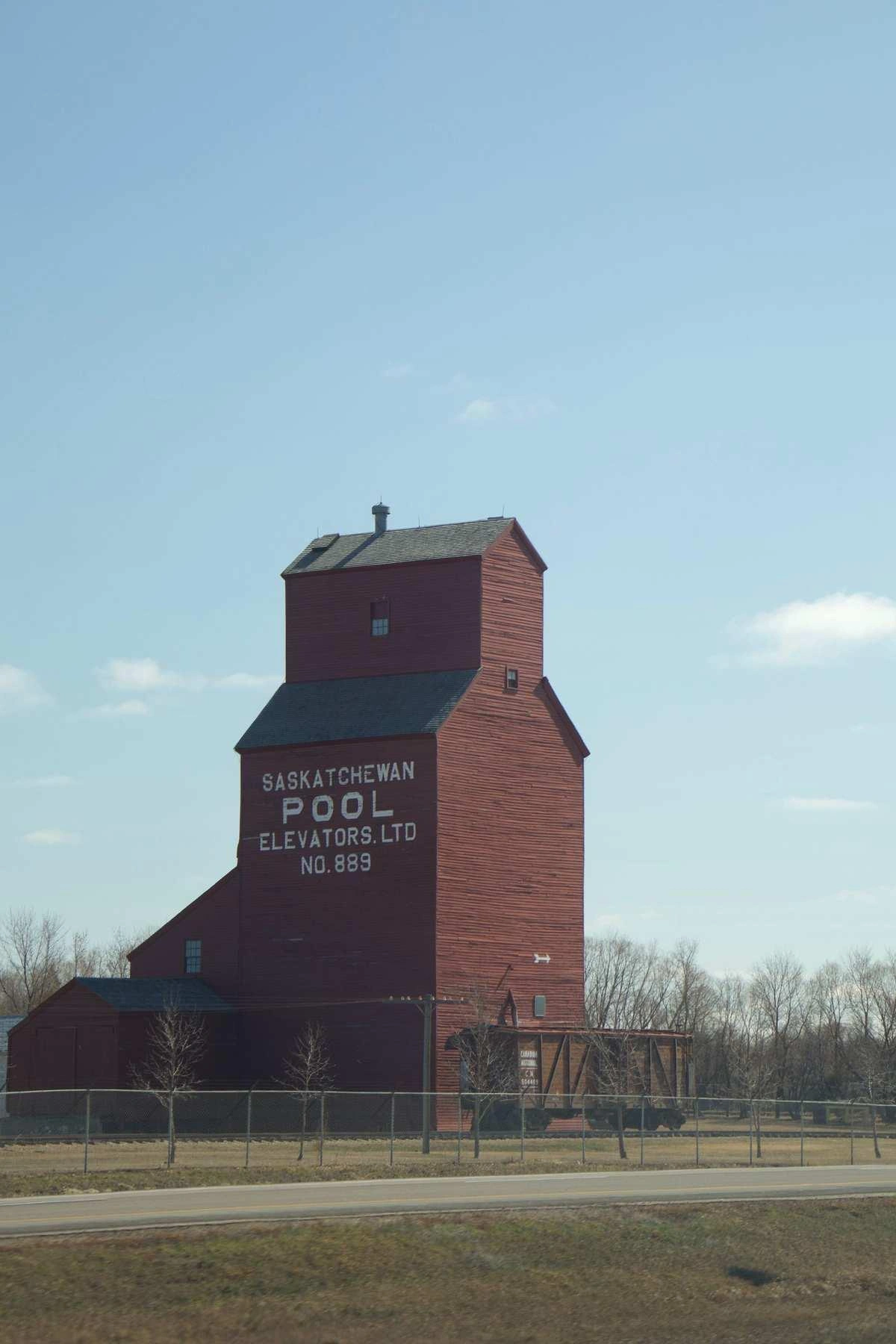 A grain elevator stands over farmland in Saskatchewan.