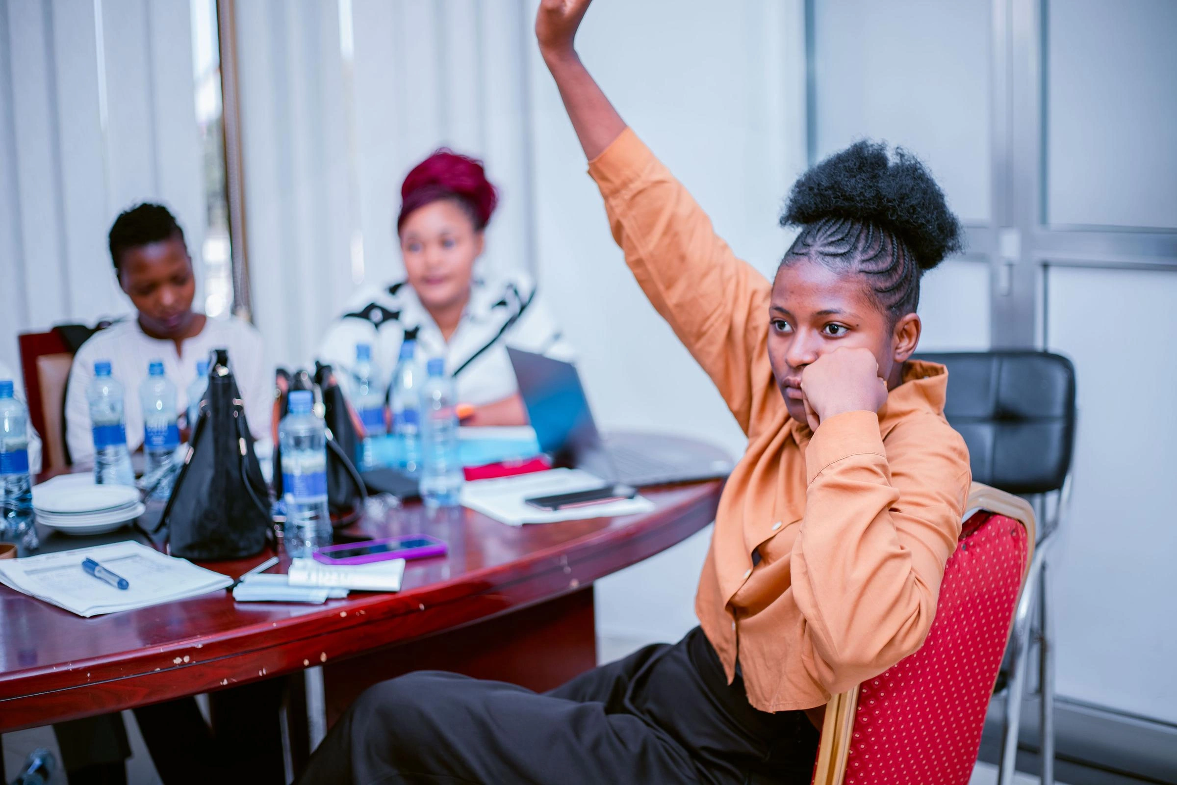 A young woman raises her hand.