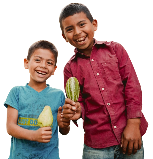 Two boys holding fruit.